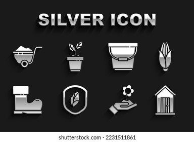Set Shield with leaf, Corn, Farm house, Hand holding flower, Waterproof rubber boot, Bucket, Wheelbarrow dirt and Plant pot icon. Vector