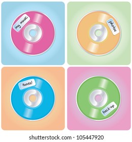 A set of shiny CD/DVDs in various colors on pastel backgrounds with handwritten labels.
