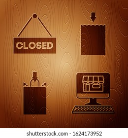 Set Shopping building on screen computer, Hanging sign with text Closed, Paper shopping bag and Paper shopping bag on wooden background. Vector