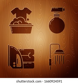 Set Shower head with water drops flowing , Plastic basin with soap suds , Electric iron and towel  and Cleaning spray bottle with detergent liquid  on wooden background. Vector