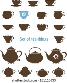 Set of silhouettes of cups, tea-pots and sugar bowls. Vector contour.