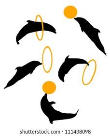 Set of silhouettes of dolphins with a hoop and a ball
