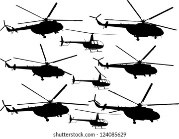 Set of silhouettes of flying helicopters