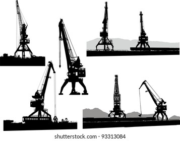 Set of silhouettes of the port cranes on a white background
