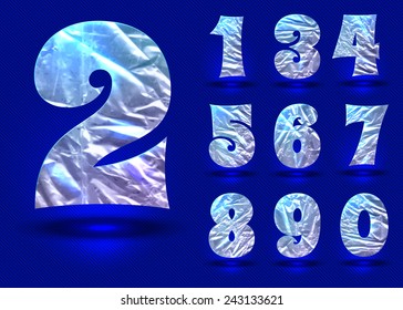 Set of silver digits on a blue background made of crumpled foil