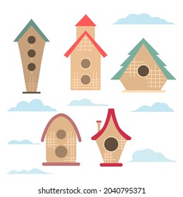 Set of simple bird houses with clouds on a white background. Vector child flat illustration of small homes. Geometric cartoon birdhouses