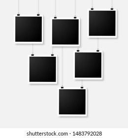 Set of six empty photo frames hanging with bulldog clip on wall. Digital snapshot image. Photography art. Template or mockup for design.