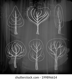 Set of six hand - drawn trees on chalkboard background 