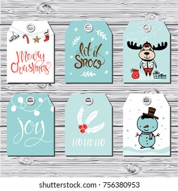 Set of six vector holiday Christmas tags with cartoon characters deer, snowman and holiday calligraphy.