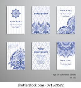 Set of six vertical business cards with oriental flowers. Backdrop with ethnic pattern. Place for your text.