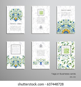 Set of six vertical business cards or tags with floral pattern and leaves on backdrop. Place for your text.