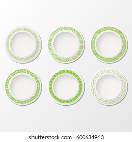 Set of six white plates with different green patterns