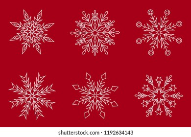 Set of six white snowflakes on a red background