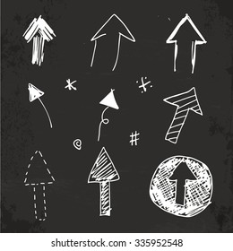 Set of sketched arrow shapes on blackboard.