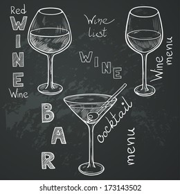 Set of sketched glasses for red wine, white wine, martini and cocktail on chalkboard background. Hand written letters in vintage style drawn with chalk on blackboard.