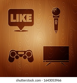 Set Smart Tv, Like in speech bubble, Gamepad and Microphone on wooden background. Vector