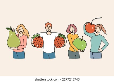 Set Of Smiling Young People Holding Huge Fruit Follow Healthy Lifestyle. Happy Men And Women With Apple, Pear And Strawberry Recommend Vegetarian Diet And Vitamin Eating. Vector Illustration. 