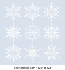 Set of snowflakes -1. White vector snowflakes on a blue  background. Beautiful winter ornament. Snowflake icons