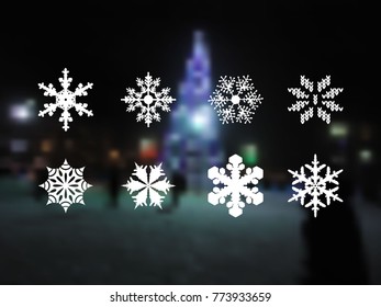 set of snowflakes. 8 kinds of snowflakes. Icons of snowflakes on a blurred background with a night landscape of a New Year tree with luminous garlands
