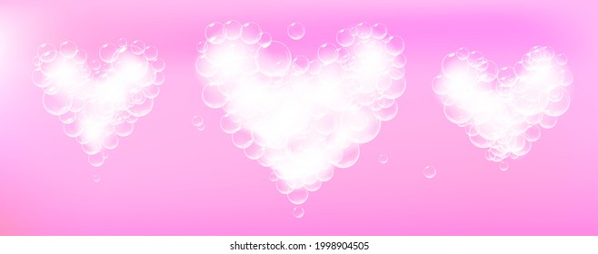 Set of soap foam pieces shaped as heart. Realistic vector soap suds. Valentine day symbol. Pink background.
