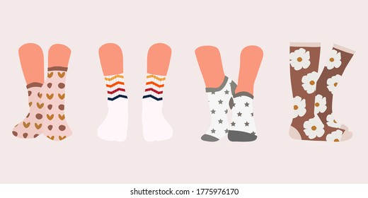 Set of socks in a different pattern. Collection of stylish cotton and woolen socks with different textures isolated on white background. Pairs of female legs in the socks. Cool various footwear prints