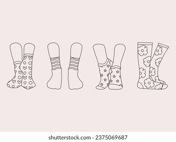 Set of socks in a different pattern. Collection of stylish cotton and woolen socks with different textures isolated on white background. Pairs of female legs in the socks. Cool various footwear prints