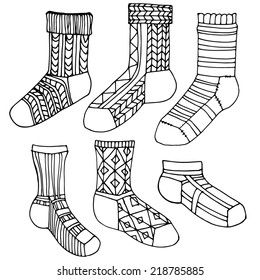 Set of socks with ornament. Stylized socks with different patterns. Black contour, hand-drawn design elements.