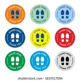 Set of stand here social distancing queue floor stickers, markers or sign. Stand here keep distance when queuing during coronavirus covid-19 lockdown pandemic