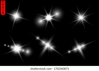 Un conjunto de bengalas estrelladas, luz brillante, una bengala solar sobre un fondo negro.