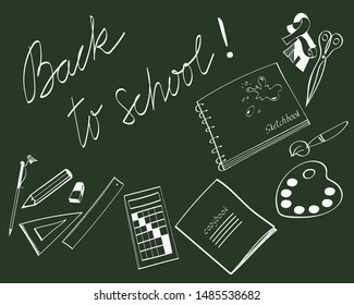 A set of stationery (school supplies) top view on a dark green background hand drawn with chalk on a chalk board with an inscription Back to school.