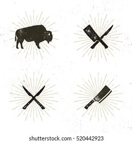 Set of steak house, butcher house and meat tools - crossed carving knives for steaks, cut, bison with sun bursts. Retro symbols of bbq equipment with letterpress effect. Stock vector.