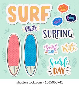 Set of stickers with hand drawn lettering phrases in speech bubbles and white outline with a pair of surfboards. Surfing theme calligraphic and typographic inscriptions on floral background. Vector