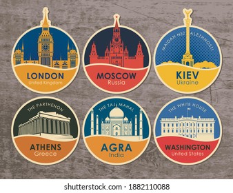 Set of stickers with the sights of the capitals of various countries. Vector illustration on the theme of travel with round emblems on a wooden background. UK, Russia, Ukraine, Greece, India, USA