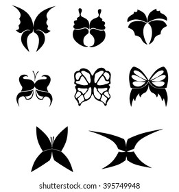 set of stylized black silhouettes of butterflies on a white background