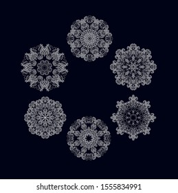 Set of stylized ornamental rosettes, mandalas on dark background