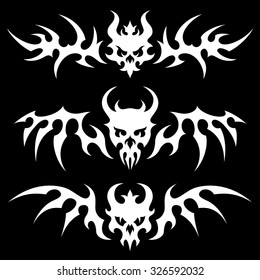 Set of stylized skulls with wings in tribal style. White illustration on black background