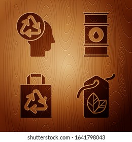 Set Tag with leaf symbol, Human head with recycle, Paper shopping bag with recycle and Oil barrel line on wooden background. Vector