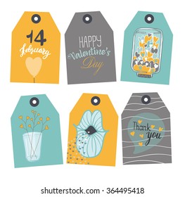 set of tags. It consists of six tags with different design. Tags are yellow, blue and gray. There are balloons, hearts, inscriptions.