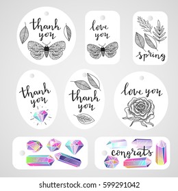 Set of tags with crystals gems, leafs, butterfly, rose flower and handwritten lettering. Black and white natural floral objects, and multicolored rainbow gems. Ink black text. Vector illustration.