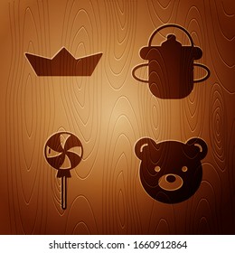 Set Teddy bear plush toy, Folded paper boat, Lollipop and Baby bottle on wooden background. Vector