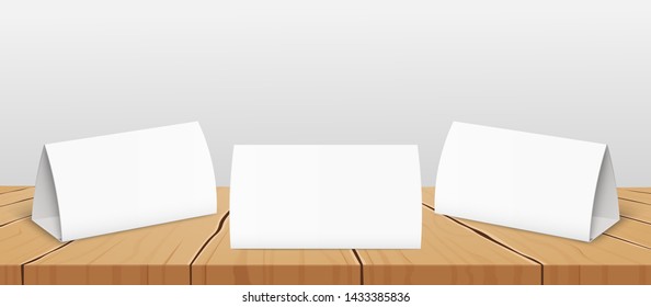 Set Of Three Blank Table Tent Cards To Presentate Your Design From All Sides 3d Realistic Vector Mockup On The Wooden Surface. Restaurant Or Event's Folded Paper Label.