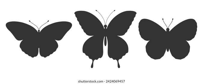 Set of three butterfly silhouettes. Insect icons, tattoos. Simple black shapes of butterflies and moths. Vector illustration