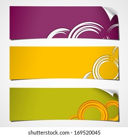 set of three color banners with curled corner and white circles colored for spring 