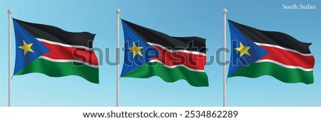 Set of three flags of South Sudan waving on flagpoles with a vibrant blue sky backdrop.