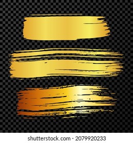 Satz von drei goldenen Pinselstrichen. Handgezeichnete Tintenflecken einzeln auf dunkeltransparentem Hintergrund. Vektorgrafik