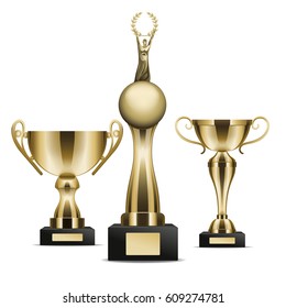 Set of three golden trophy cups winner graphic art icon. Vector illustration of realistic trophies isolated on white. Gold rewards on black base with nameplate. Drawn figure cartoon style flat design.