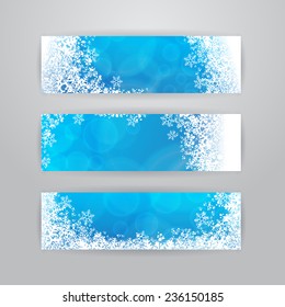 Set of three horizontal banners with snowflakes on blue blurry background