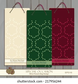 Set of three mock-up Wine Gift Bags on wood texture. Red, white & any wine or spirit present bag design.  Abstract hexagon pattern is masked. Pomegranate icon. Vector is easily editable.