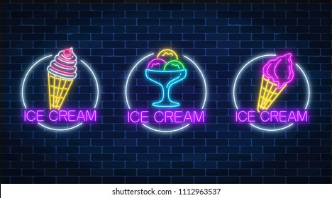 Set of three neon glowing signs of different kinds of ice cream in circle frames on a dark brick wall background. Ice-cream light billboard symbol. Cafe menu item. Vector illustration.