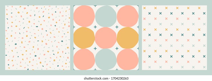 Set of three seamless vector patterns. Hand-drawn circles, stars, cross-stitches, terrazzo texture. Neutral pastel square designs collection.Trendy print in yellow, blue, pink on off-white background.